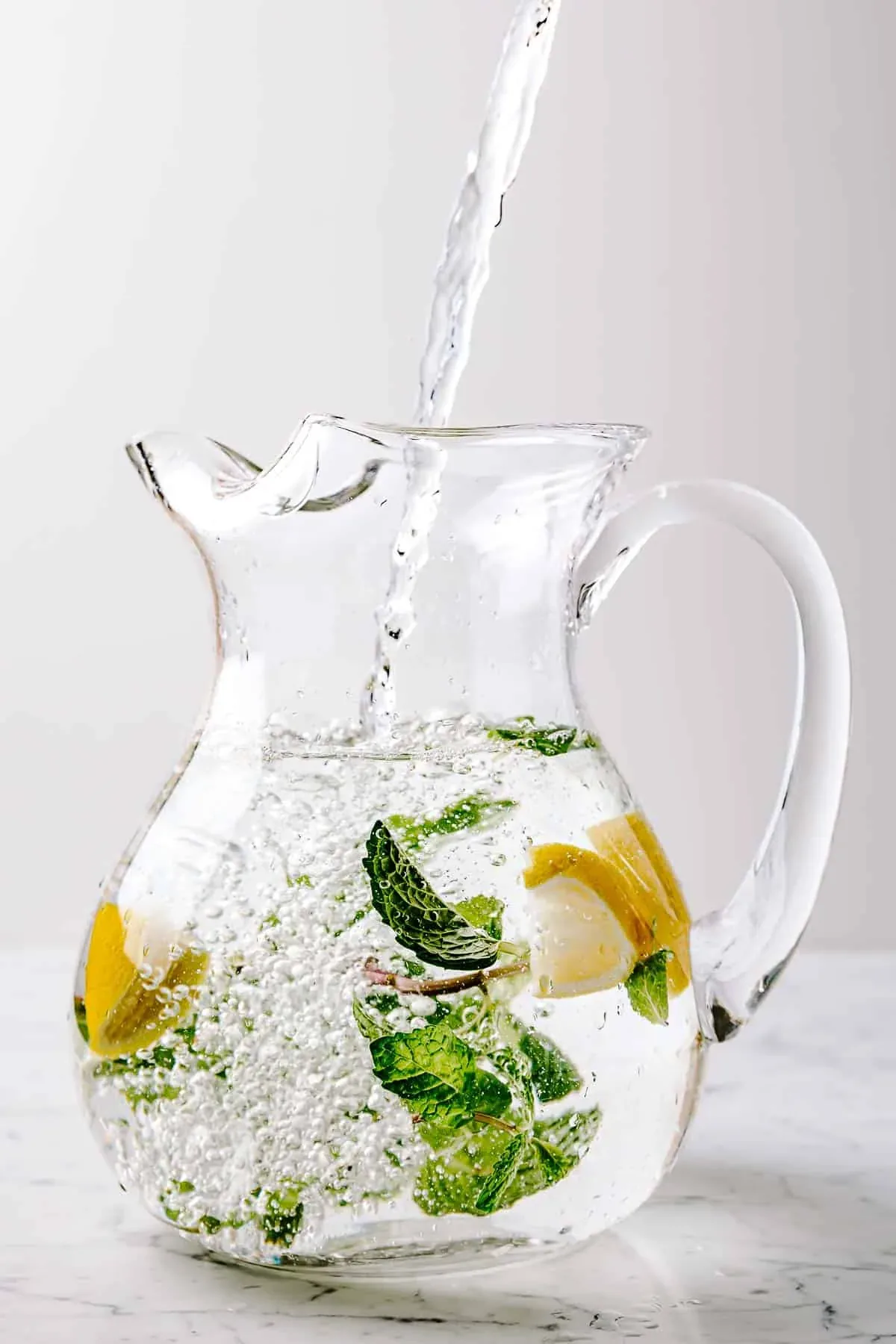 Fresh water infused with lemon and mint in a clear glass