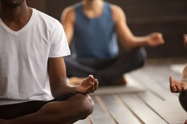 Person practicing mindfulness and breathing balance in morning sunlight